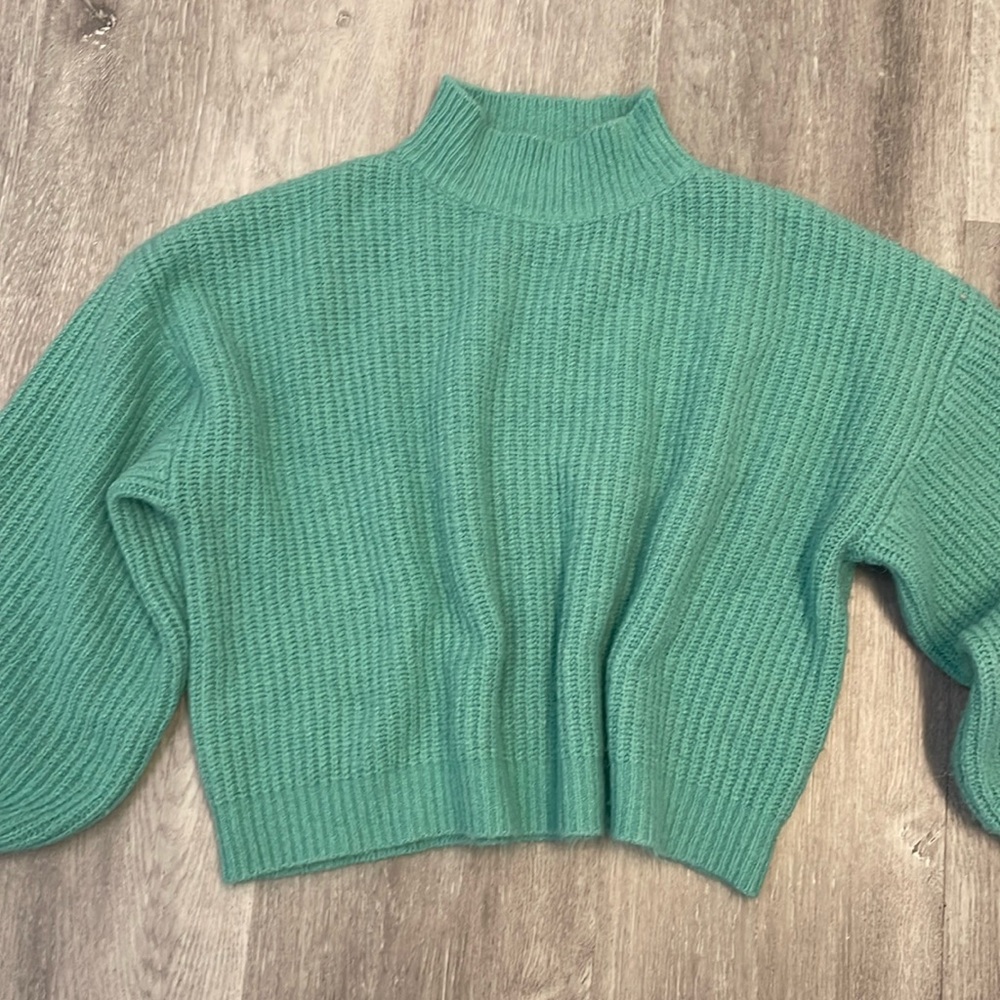 Anna Grace large teal sweater with slightly domed sleeves.